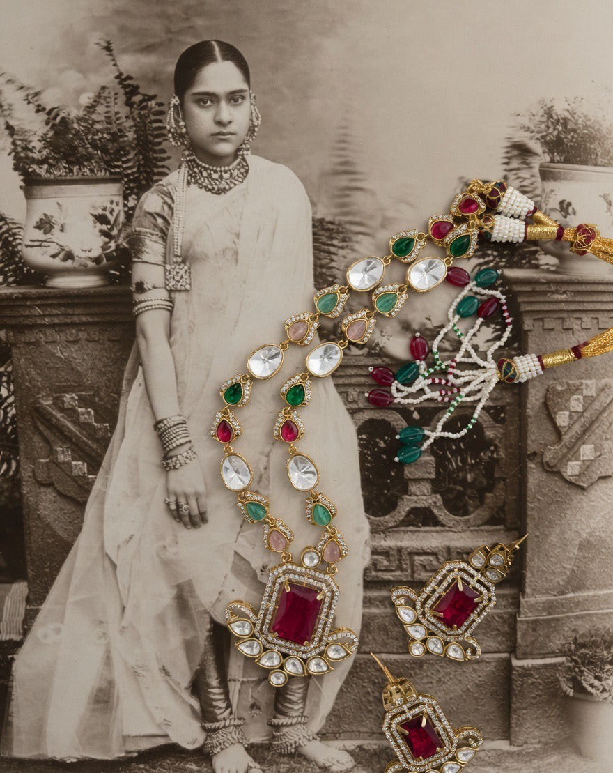 Vintage photograph of a woman in traditional attire with jewelry displayed in front